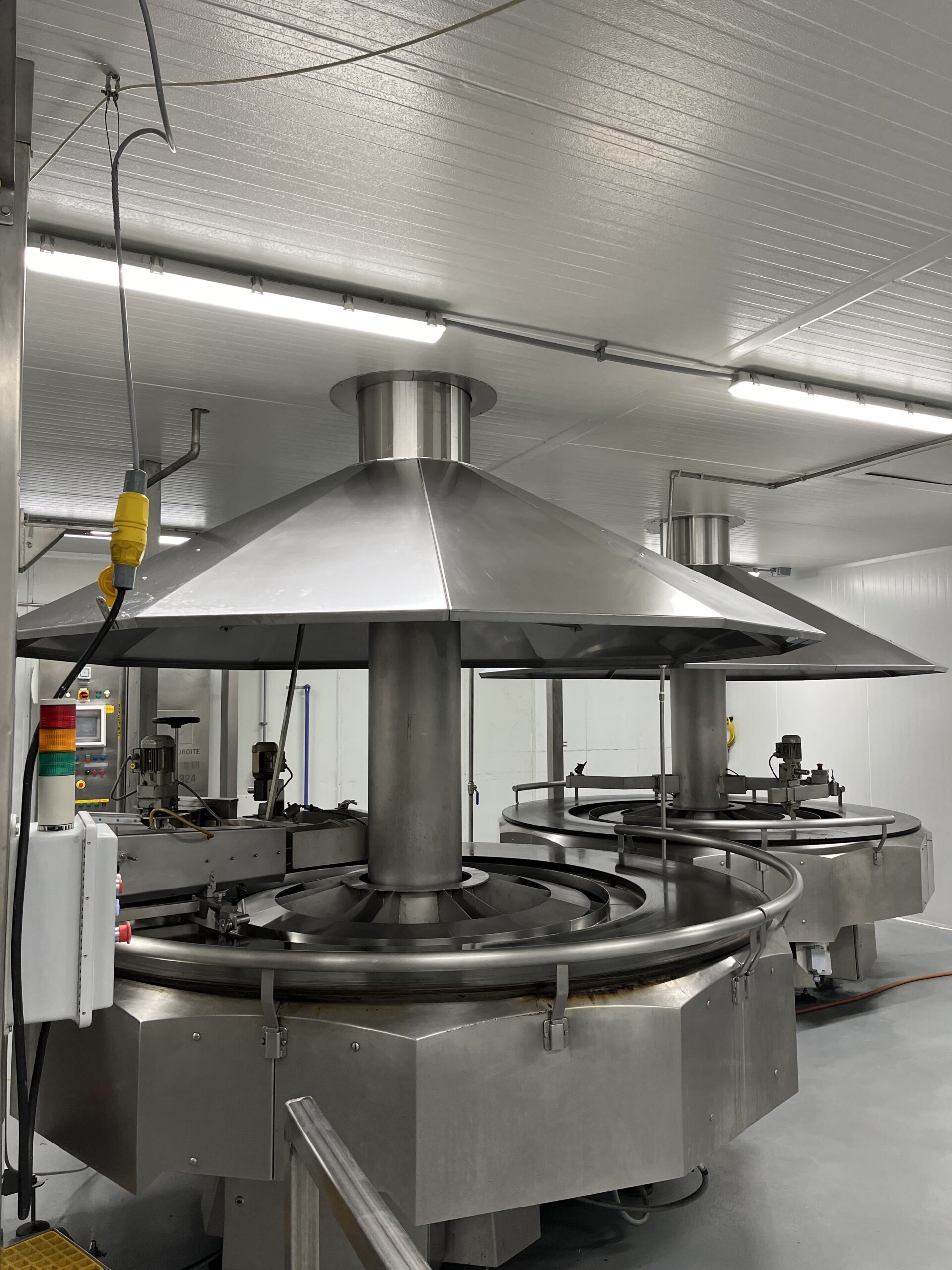 Heated rotary tables in an industrial crepe manufacturing facility in North America, designed for producing flat and rolled crepes.